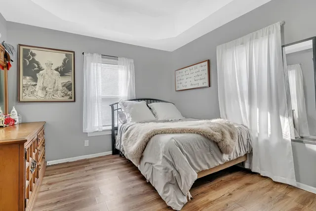 a bedroom with a bed and a painting on the wall