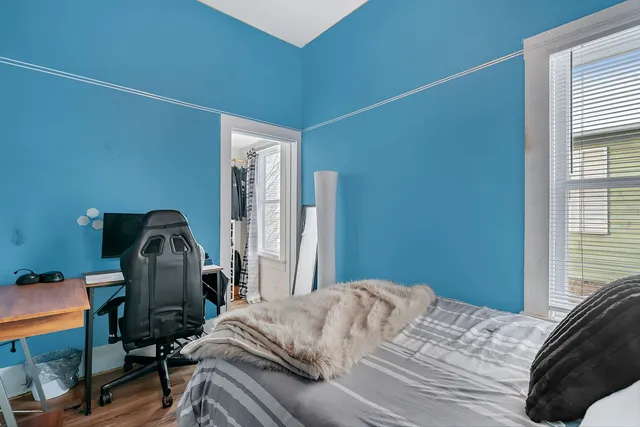 a bedroom with a bed and a window