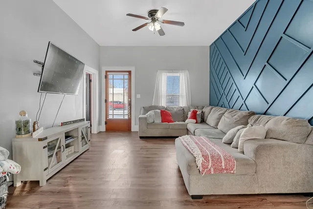 a living room with furniture and a flat screen tv