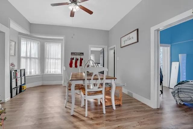 a view of a dining room with furniture window and wooden floor