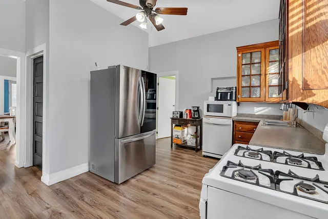 a kitchen with stainless steel appliances granite countertop a stove a refrigerator and a refrigerator