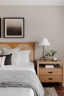 a bedroom with a bed and lamp