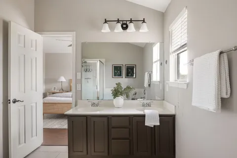 a bathroom with a double vanity sink and a mirror