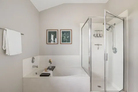 a bathroom with a bathtub and a shower