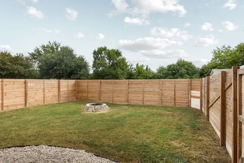 a backyard of a house with lots of green space and mountain view in back