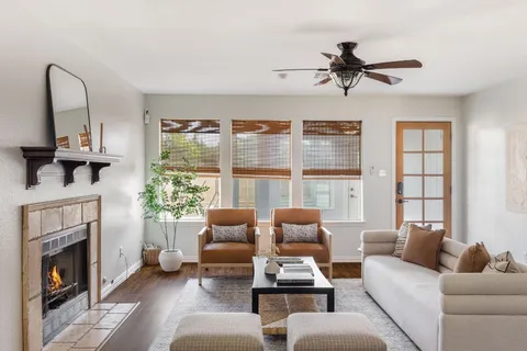 a living room with furniture and a fireplace