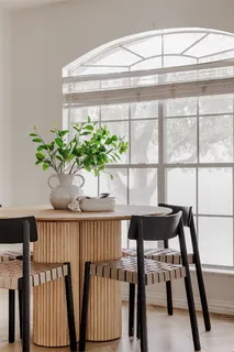 a dining room with furniture window and outside view