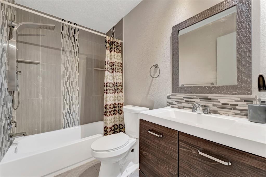 13300 Walsingham Road, Unit 56 Largo, FL 33774 - Photo 22 of 35 a bathroom with a sink a toilet and shower