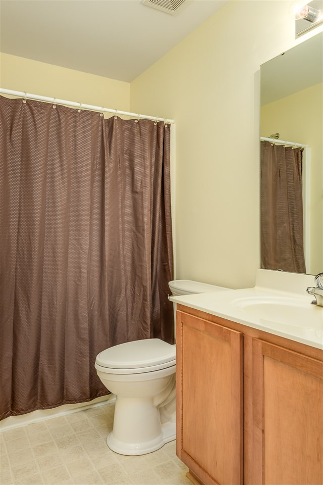 3525 Oneonta Avenue Raleigh, NC 27604 - Photo 19 of 22 a bathroom with a toilet a sink and curtain