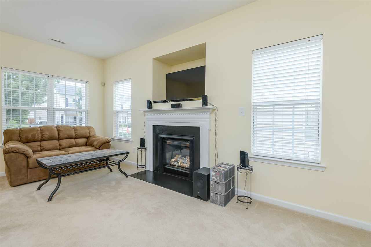 3525 Oneonta Avenue Raleigh, NC 27604 - Photo 5 of 22 a living room with furniture a flat screen tv and a fireplace