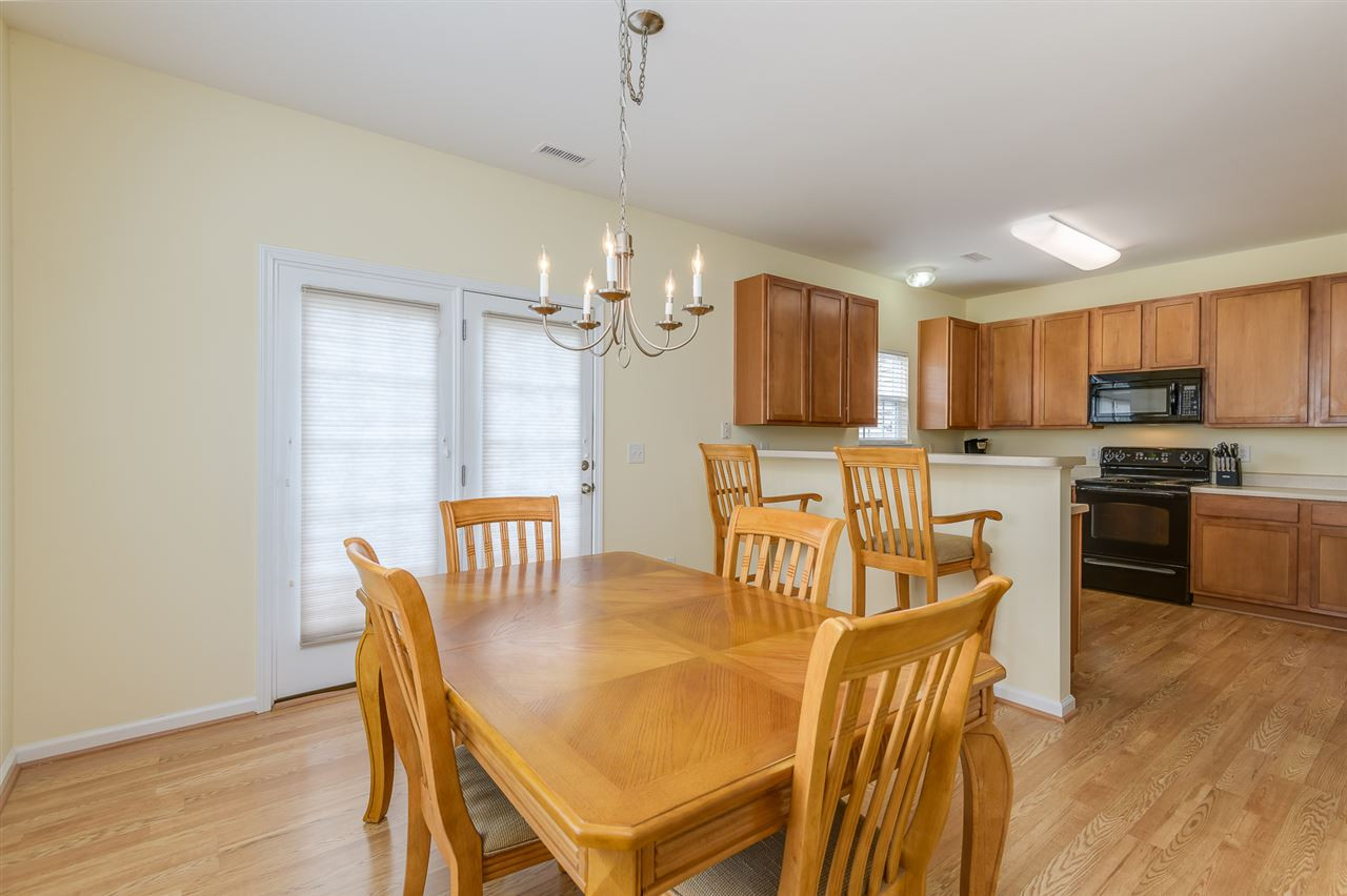 3525 Oneonta Avenue Raleigh, NC 27604 - Photo 7 of 22 a view of a dining room with furniture and wooden floor