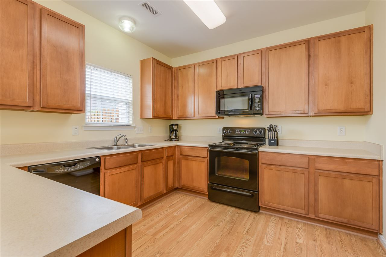 3525 Oneonta Avenue Raleigh, NC 27604 - Photo 9 of 22 a kitchen with granite countertop wooden cabinets and a stove top oven