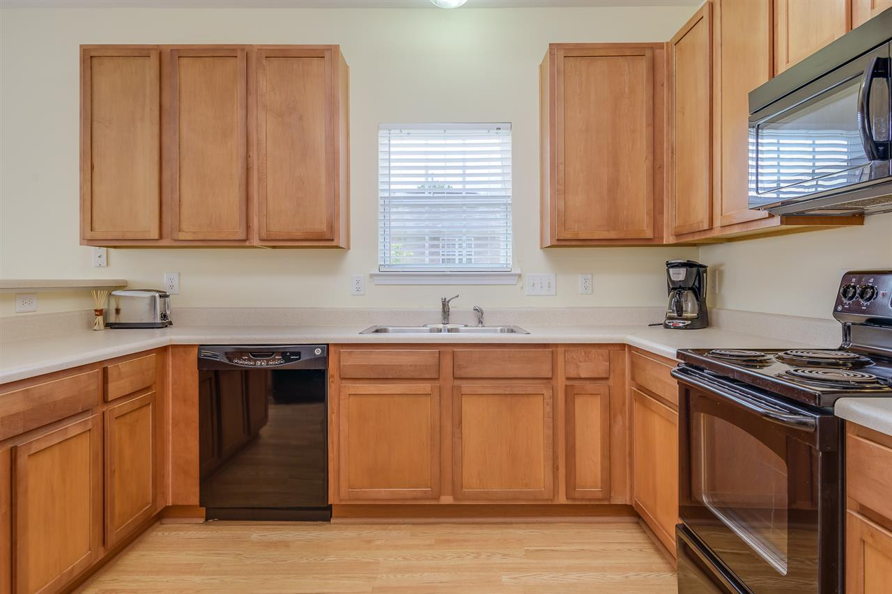3525 Oneonta Avenue Raleigh, NC 27604 - Photo 10 of 22 a kitchen with stainless steel appliances granite countertop a sink stove and cabinets