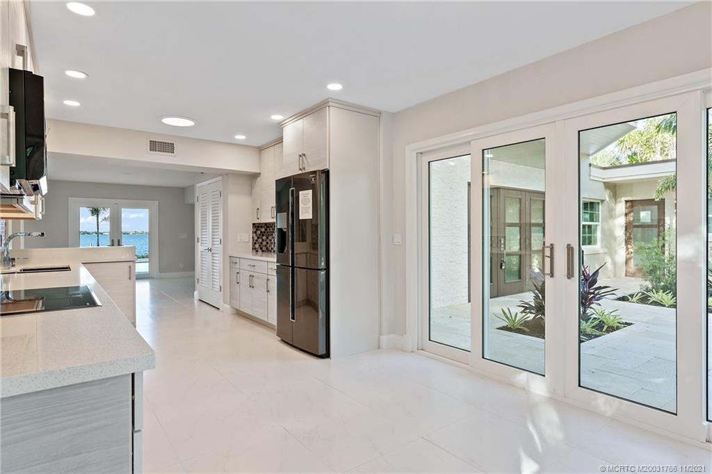 1037 Southeast Riverside Drive Stuart, FL 34996 - Photo 15 of 46 The kitchen is well lit and has plenty of "eat in" functionality and lovely patio, garden views.