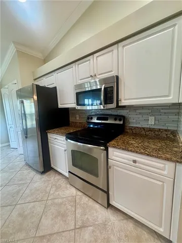 a kitchen with a stove and a microwave