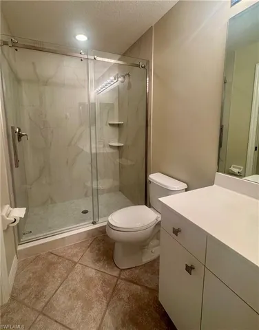 a bathroom with a toilet sink and shower