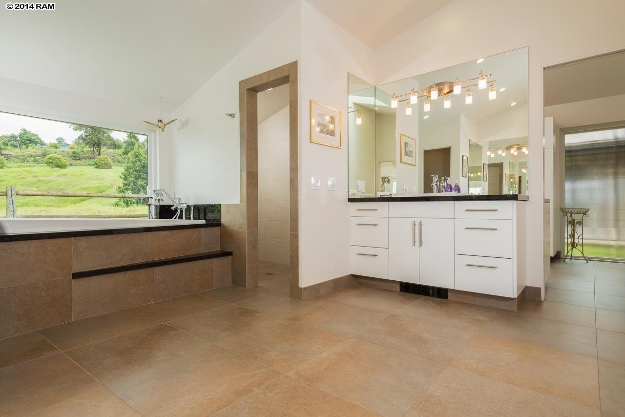 8037 Kula Highway Kula, HI 96790 - Photo 13 of 30 a bathroom with a sink a mirror and a bathtub