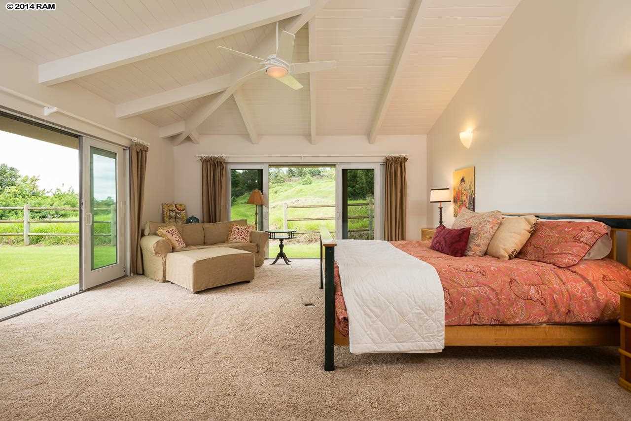 8037 Kula Highway Kula, HI 96790 - Photo 14 of 30 a bedroom with a bed and large window