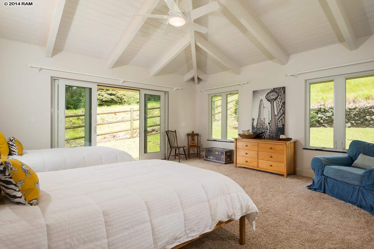 8037 Kula Highway Kula, HI 96790 - Photo 16 of 30 a large bedroom with a bed and large windows