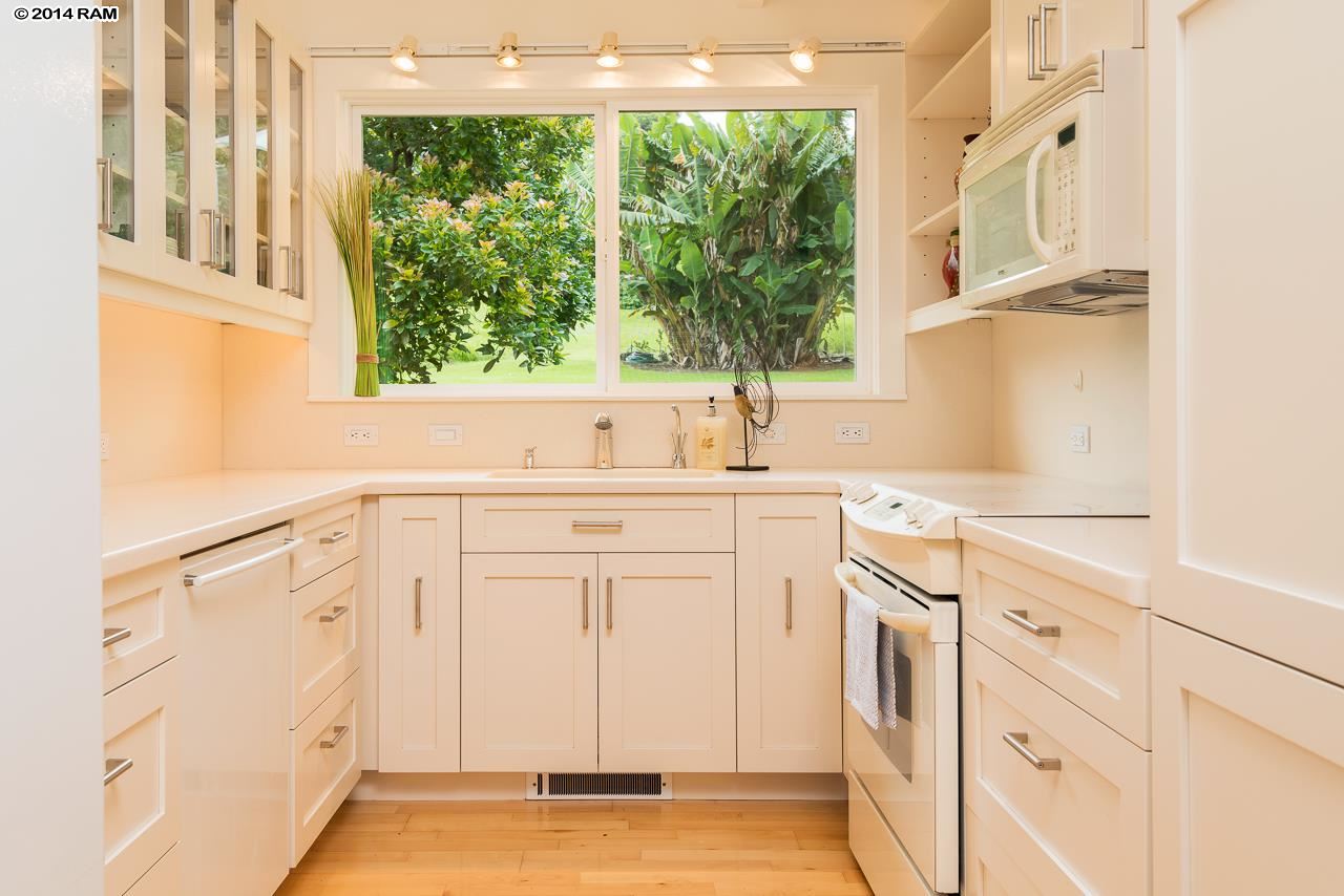 8037 Kula Highway Kula, HI 96790 - Photo 26 of 30 a kitchen with white cabinets and a window