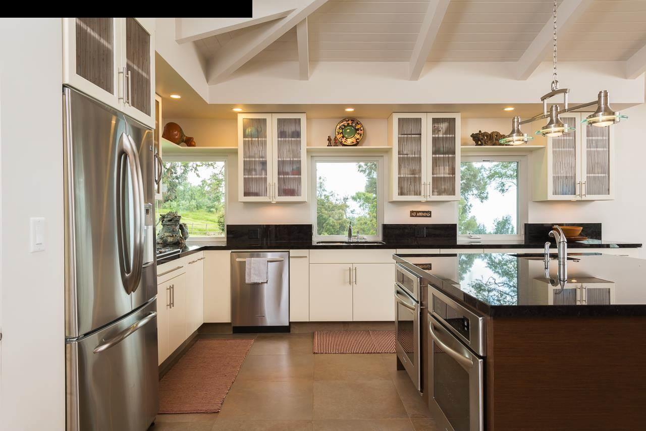 8037 Kula Highway Kula, HI 96790 - Photo 3 of 30 a kitchen with stainless steel appliances granite countertop a refrigerator and a sink