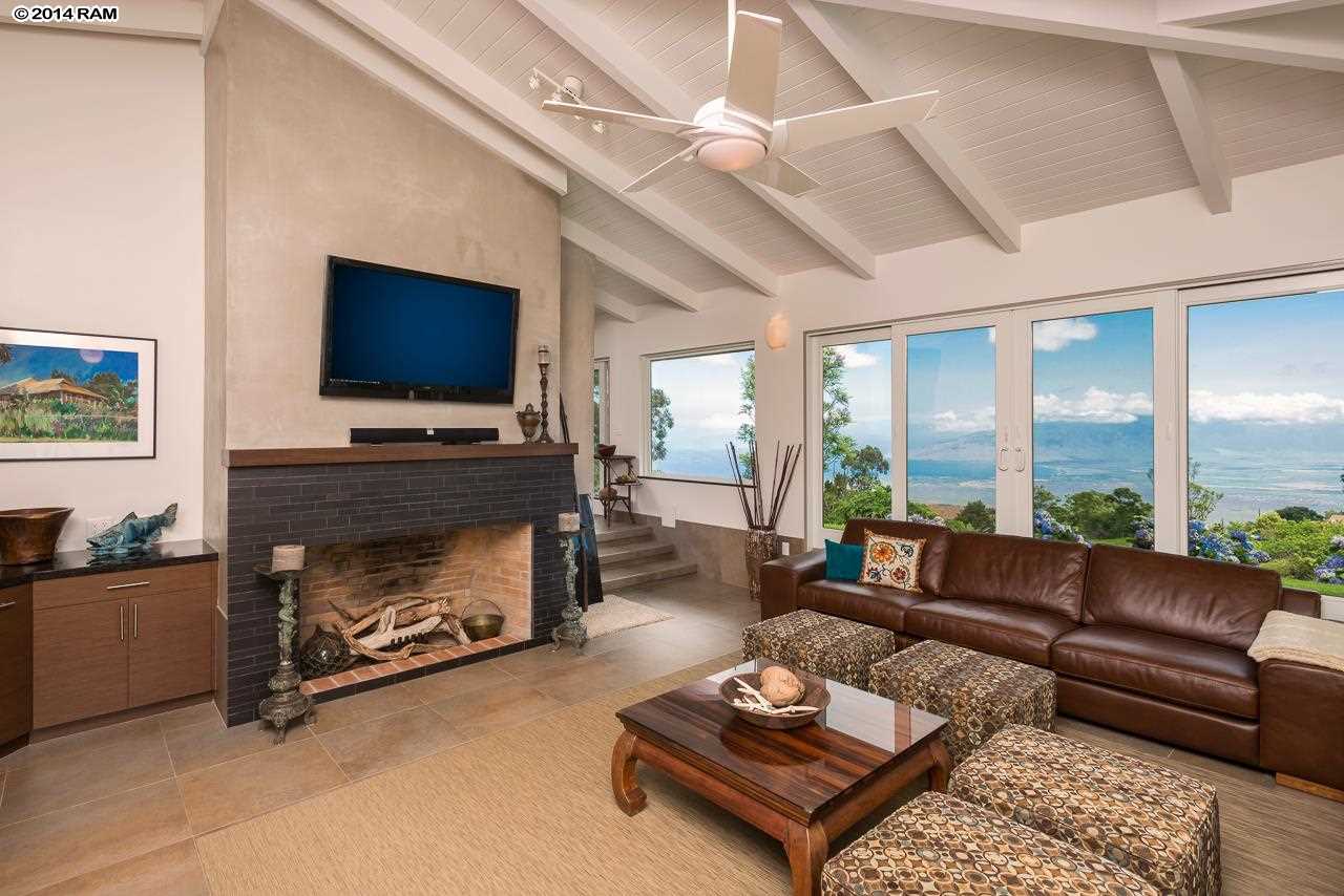 8037 Kula Highway Kula, HI 96790 - Photo 7 of 30 a living room with furniture a flat screen tv and a fireplace