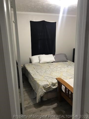 1920 Sapona Road Fayetteville, NC 28312 - Photo 11 of 15 a bedroom with a bed and a mirror