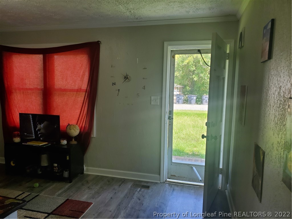 1920 Sapona Road Fayetteville, NC 28312 - Photo 4 of 15 a view of a hallway with wooden floor and a window