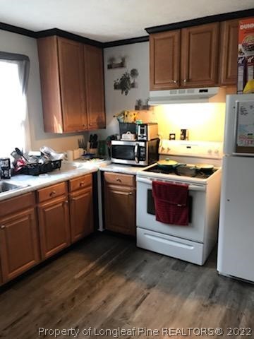 1920 Sapona Road Fayetteville, NC 28312 - Photo 6 of 15 a kitchen with a stove sink and cabinets