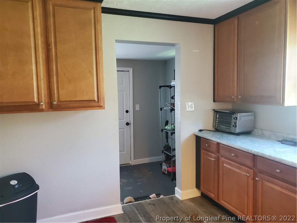 1920 Sapona Road Fayetteville, NC 28312 - Photo 7 of 15 a room with cabinets and wooden floor