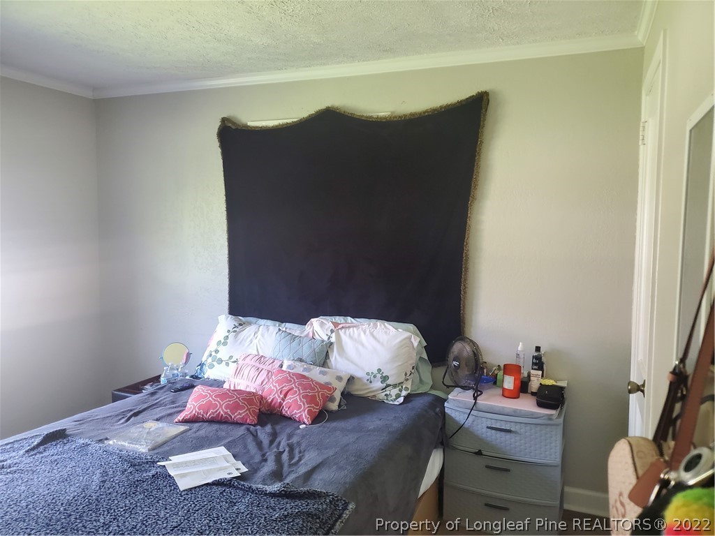 1920 Sapona Road Fayetteville, NC 28312 - Photo 9 of 15 a bedroom with bed and a couch