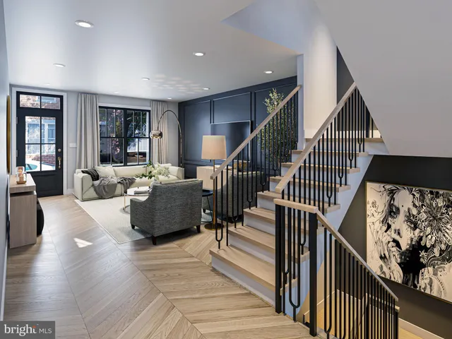 a living room with wooden floor and stairs