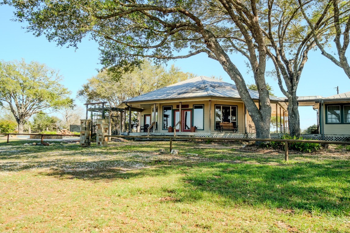 a view of a house with a yard balcony and sitting area