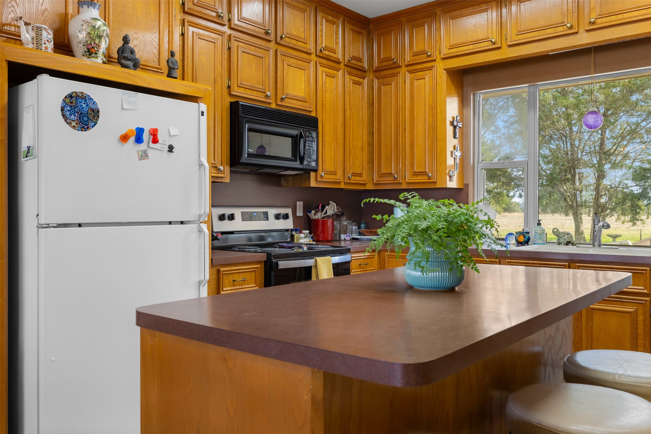 2346 Bruno Road Schulenburg, TX 78956 - Photo 16 of 49 a kitchen with stainless steel appliances granite countertop a sink a stove and a refrigerator