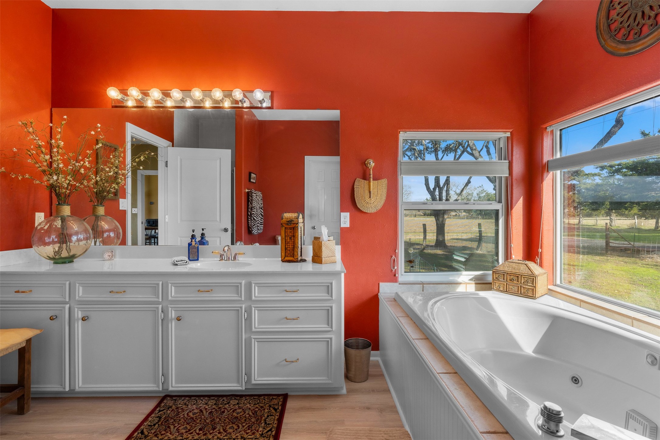 2346 Bruno Road Schulenburg, TX 78956 - Photo 20 of 49 a large bathroom with a double vanity sink a mirror and a bathtub