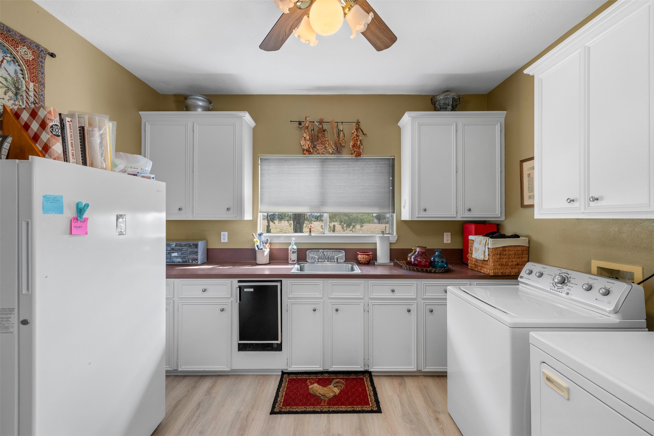 2346 Bruno Road Schulenburg, TX 78956 - Photo 23 of 49 a kitchen with a sink cabinets and wooden floor