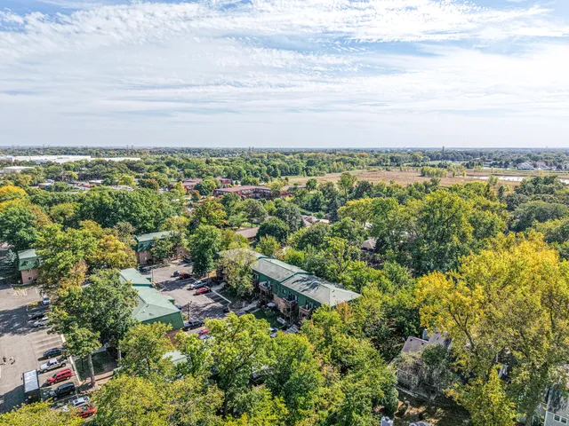 an aerial view of residential house with outdoor space and trees