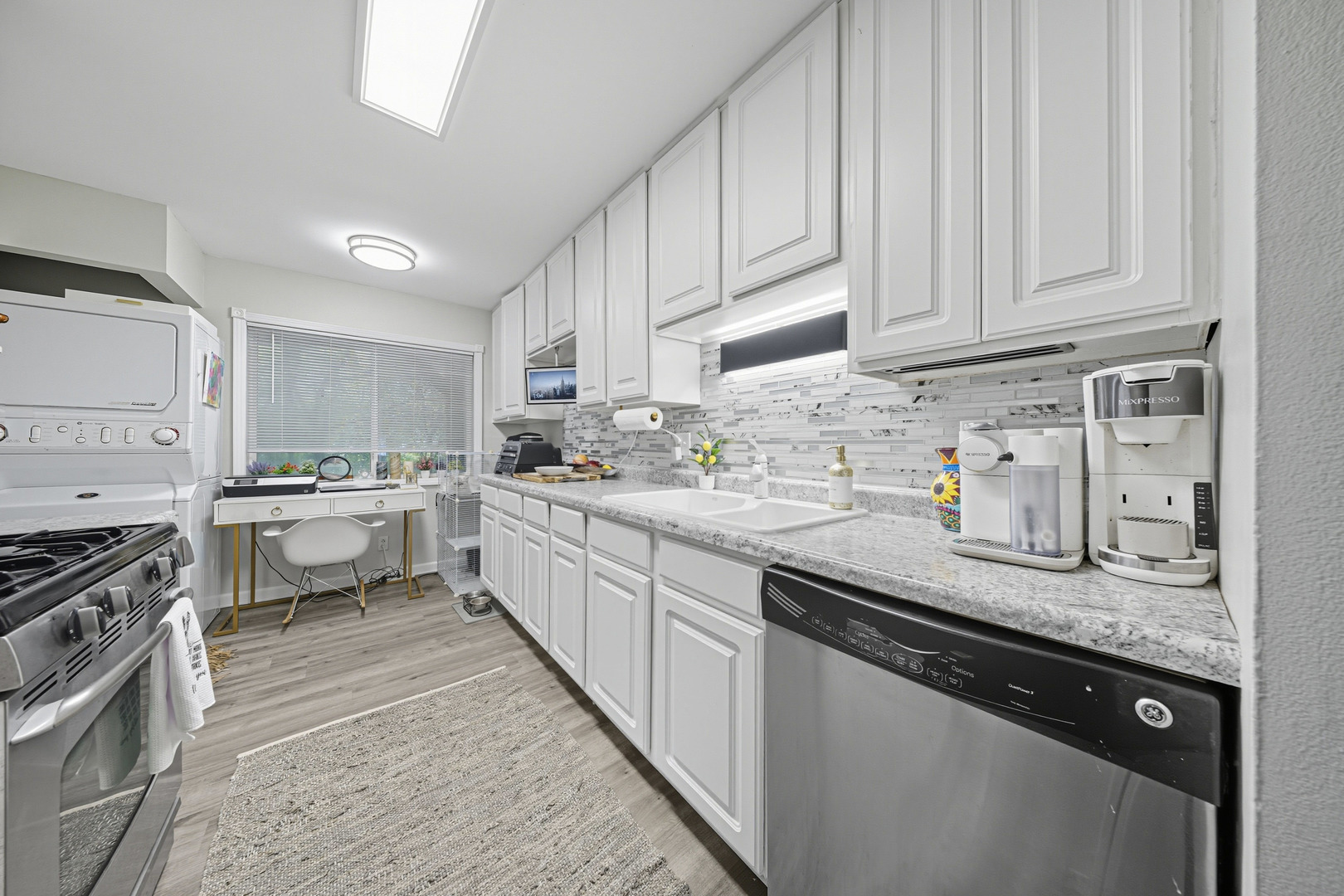 1942 Tall Oaks Drive, Unit 1A Aurora, IL 60505 - Photo 4 of 13 a kitchen with stainless steel appliances granite countertop a sink stove and cabinets