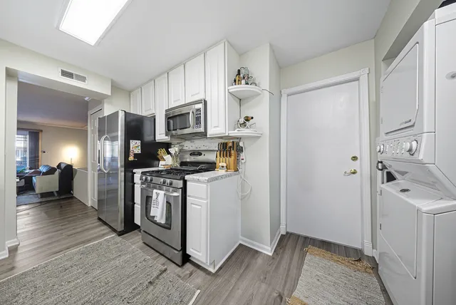 a kitchen with stainless steel appliances a refrigerator and a stove top oven