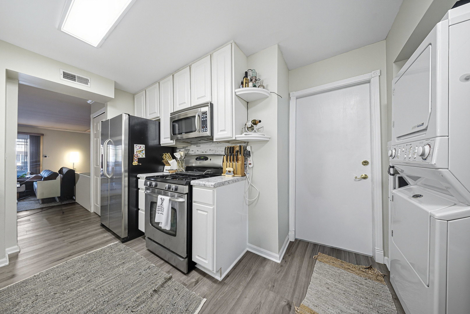 1942 Tall Oaks Drive, Unit 1A Aurora, IL 60505 - Photo 6 of 13 a kitchen with stainless steel appliances a refrigerator and a stove top oven