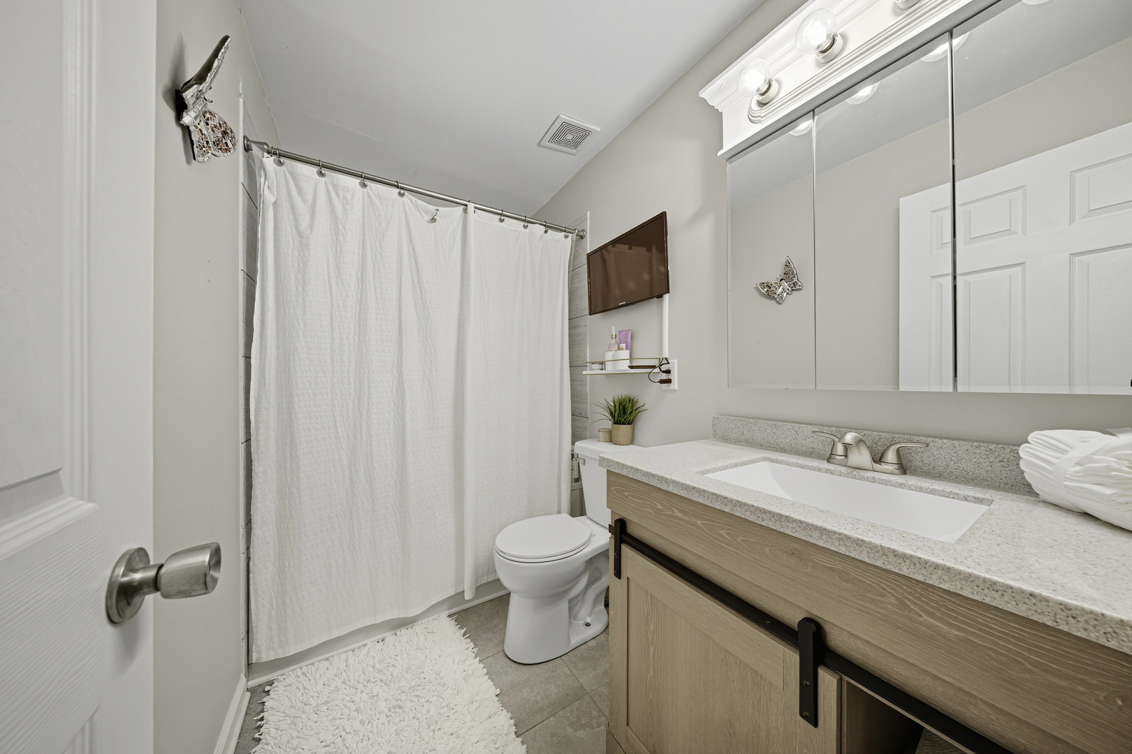 1942 Tall Oaks Drive, Unit 1A Aurora, IL 60505 - Photo 8 of 13 a bathroom with a sink a toilet and shower