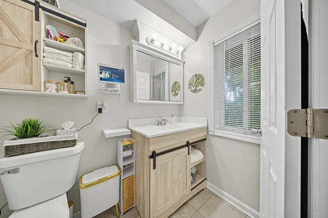 a bathroom with a sink toilet and window