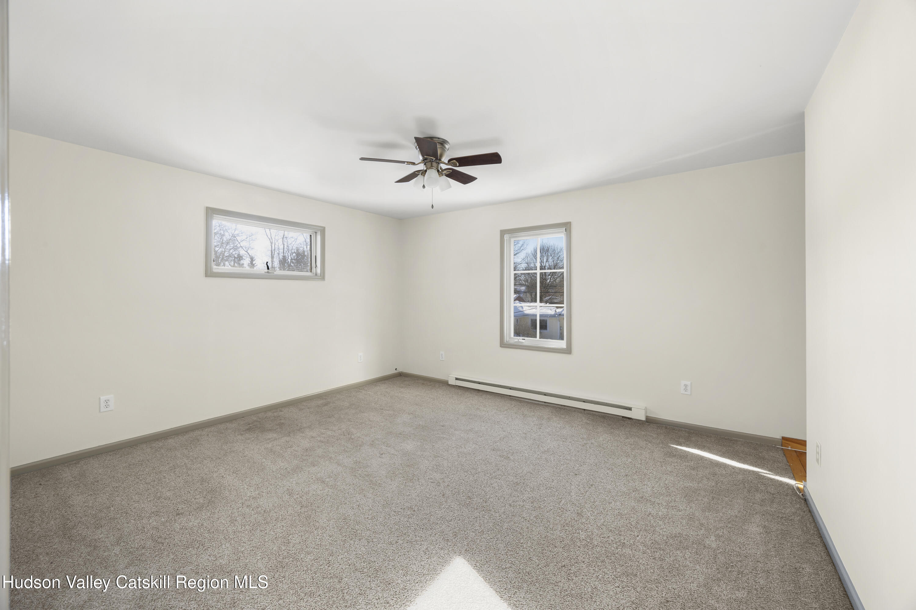 116 Lincoln Road Copake, NY 12516 - Photo 12 of 20 an empty room with windows and ceiling fan