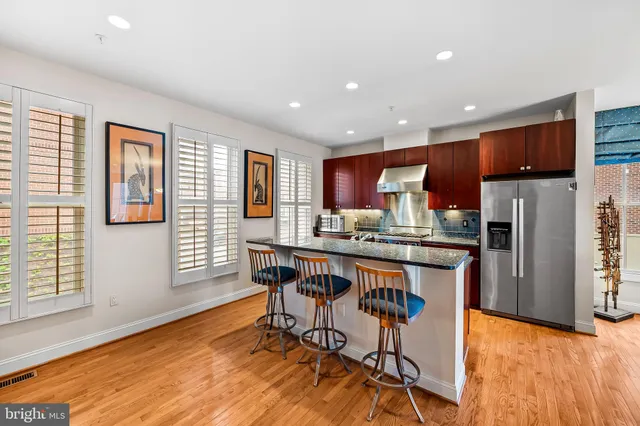 a living room with furniture wooden floor and a flat screen tv