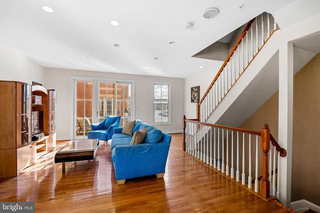 a living room with furniture window and a wooden floor