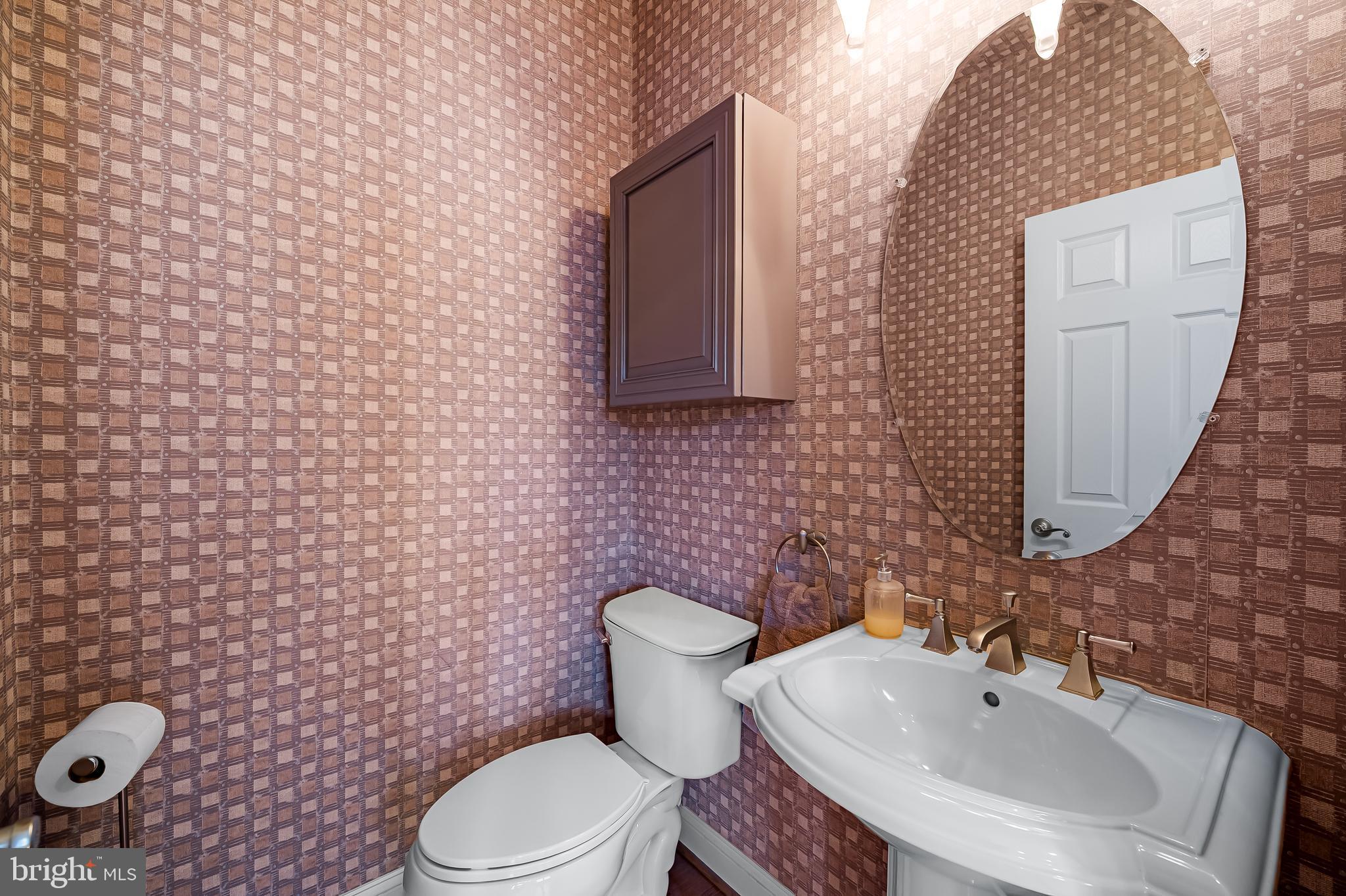 2323 Boston Street, Unit 6 Baltimore, MD 21224 - Photo 15 of 47 a bathroom with a sink a toilet and mirror