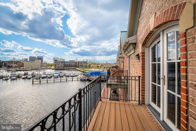 a view of a balcony with wooden floor and fence