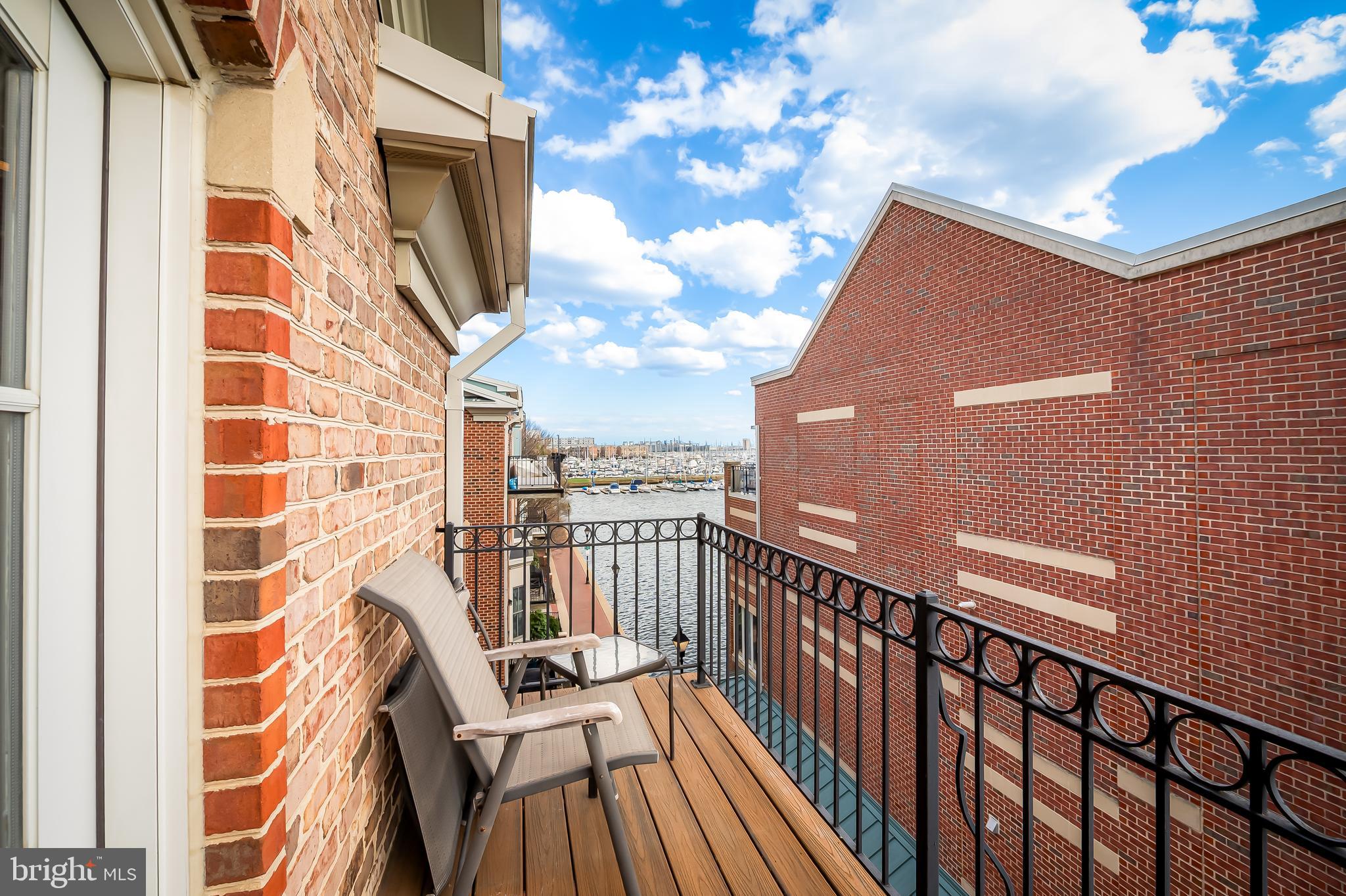 2323 Boston Street, Unit 6 Baltimore, MD 21224 - Photo 20 of 47 a view of a balcony with wooden floor and fence