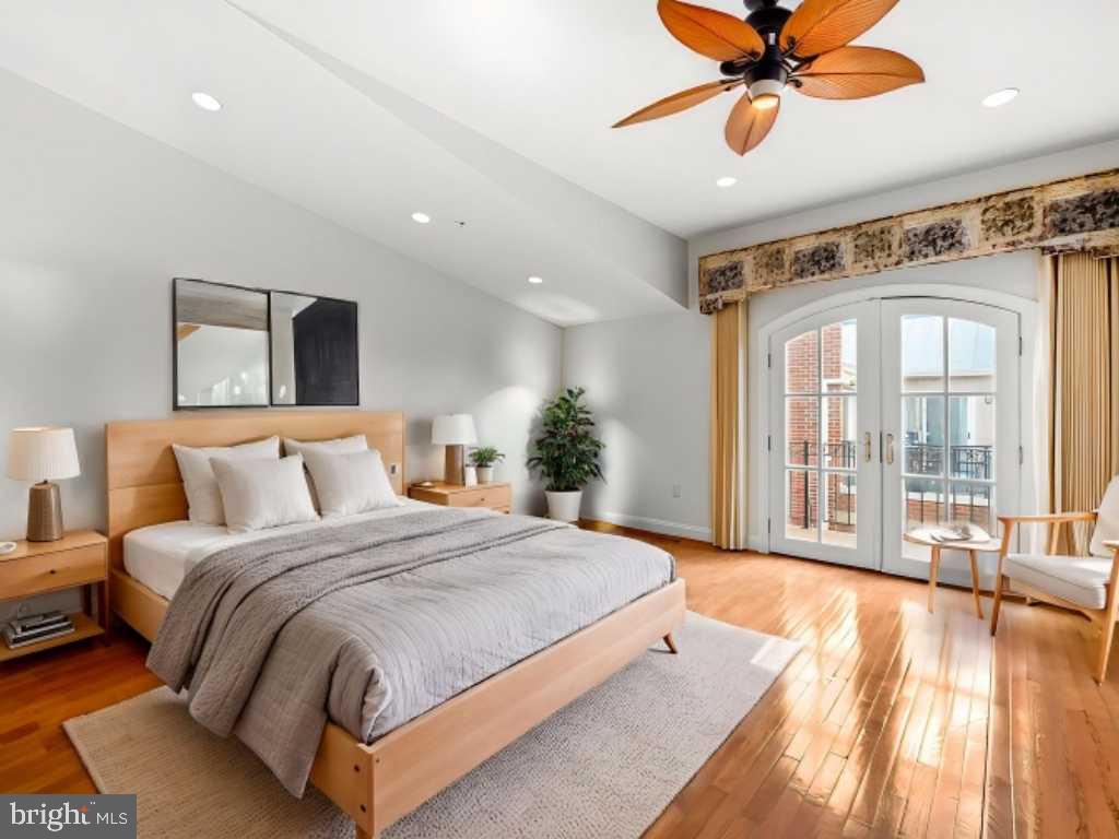 2323 Boston Street, Unit 6 Baltimore, MD 21224 - Photo 23 of 47 a spacious bedroom with a large bed and a chandelier