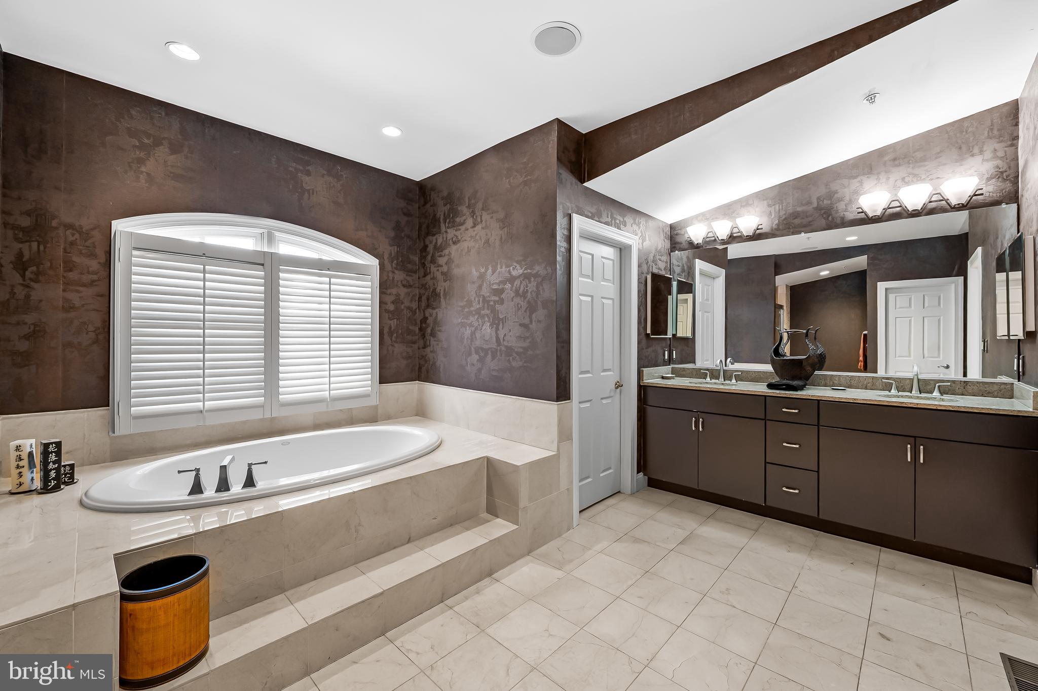 2323 Boston Street, Unit 6 Baltimore, MD 21224 - Photo 24 of 47 a large white bathroom with a large tub a sink and a large window